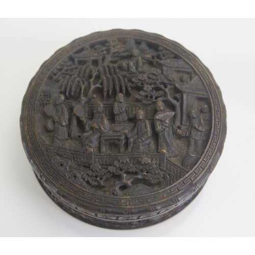 1268 - A 19th Century Chinese carved tortoiseshell snuff box of circular form, decorated in low relief of f... 