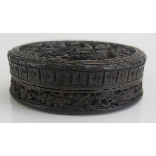 1268 - A 19th Century Chinese carved tortoiseshell snuff box of circular form, decorated in low relief of f... 