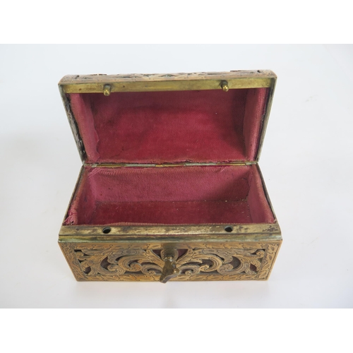 1282 - A brass mounted trinket casket, of rectangular outline, the domed hinged lid enclosing a velvet line... 