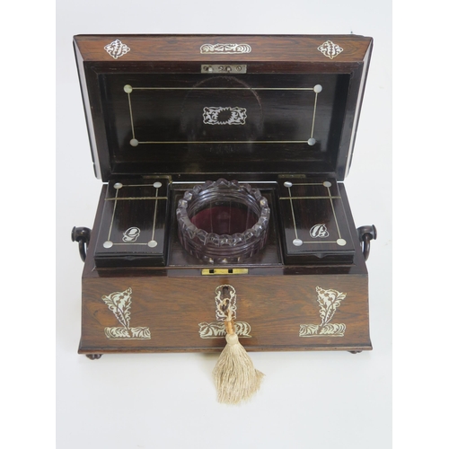 1285 - A 19th century rosewood and mother-of-pearl inlaid tea caddy, of sarcophagus outline, the hinged lid... 