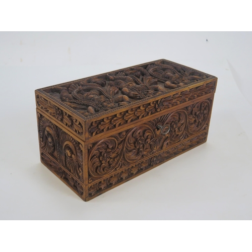 1290 - A 20th century Indian carved hardwood box, of rectangular outline, the hinged lid decorated with dan... 