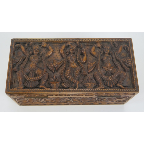 1290 - A 20th century Indian carved hardwood box, of rectangular outline, the hinged lid decorated with dan... 