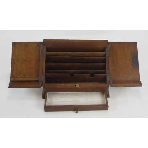 1291 - A late Victorian walnut stationery box, the hinged sloping doors enclosing a fitted interior with si... 