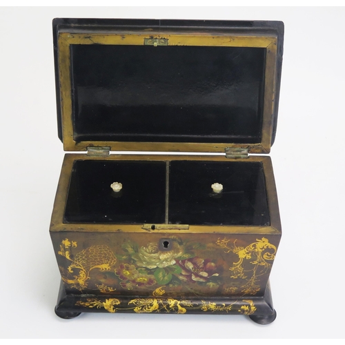 1300 - A 19th century papier mache tea caddy, of rectangular outline, the hinged lid enclosing two lidded z... 