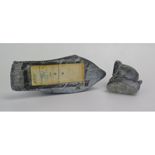 1612 - An Inuit carved hardstone model of a recumbent seal, with paper label to the base, 20cm long, togeth... 