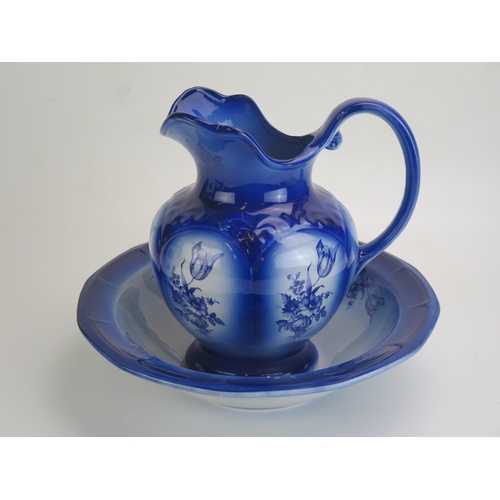 1642 - A Victorian style wash basin and jug with blue floral decoration,