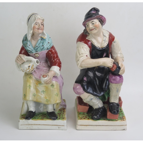 1643 - A pair of Staffordshire style figure, 'The Cobbler' and 'His Wife, raised on plinth bases, 32cm high... 