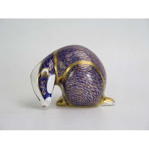 1650 - A Royal Crown Derby paperweight in the form of a badger, with silver coloured stopper