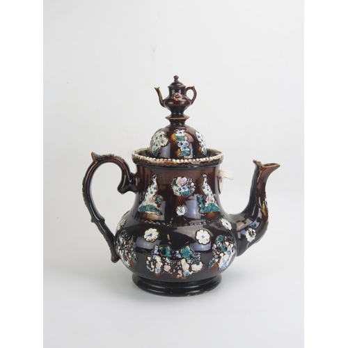 1662 - A large barge-ware teapot, with brown treacle glaze with applied flowerhead and bird decoration, the... 