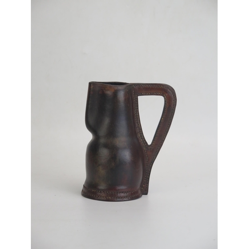 1718 - A Leather Black Jack Jug, 15cm tall