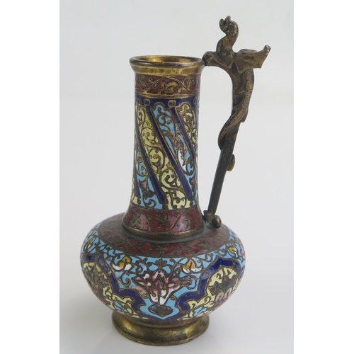 1745 - A late 19th century bronze and champlevé enamel vase, of squat bulbous form, the handle surmounted b... 