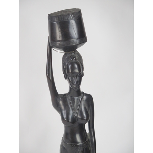 1761 - A large African carved hardwood figure of a female water carrier, 103cm high.