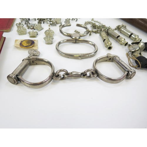 1787 - Two pairs of polished steel handcuffs, Metropolitan whistles, Devon Constabulary buttons, badges, bo... 