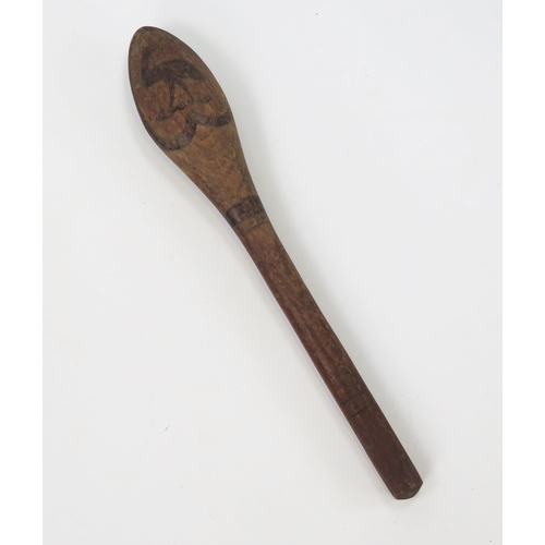 1825 - An Aboriginal club, the oval head decorated with a kangaroo and an emu, on slender shaft 60cm long.