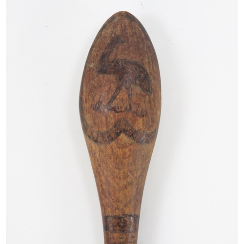 1825 - An Aboriginal club, the oval head decorated with a kangaroo and an emu, on slender shaft 60cm long.