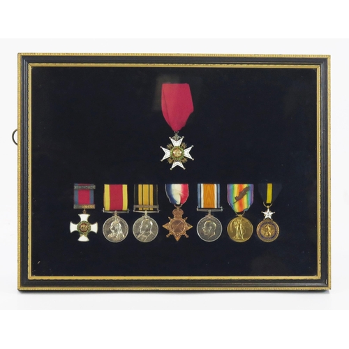 A DSO Group of Eight Medals to Vice Admiral Harry Rowlandson Godfrey RN, comprising C.B., D.S.O., China War Medal, African General Service Medal with Somaliland 1902-04 clasp, 1914-15 Star, War Medal, Victory Medal with M.I.D. oakleaf and American Distinguished Service Medal, framed and glazed, together with assorted photographs in uniform and family portraits, a watercolour depicting HMS Britannia, 31 x 47cm, a Book of Common Prayer with hand written frontis piece giving dates were Christmas was spent from 1892 - 1926, the back page is hand written with dates and ships served on from 1890 - 1926.