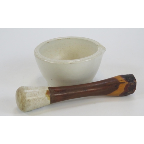 1838 - A large stoneware mortar and pestle with polished wood handle.