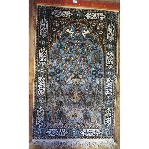 1846 - A Persian silk prayer rug, the powder blue field with arched mirab decorated with a vase of flowers ... 