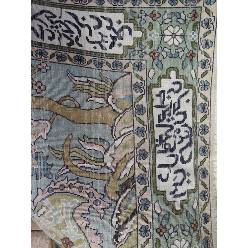 1846 - A Persian silk prayer rug, the powder blue field with arched mirab decorated with a vase of flowers ... 