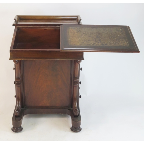 805 - A Victorian Walnut Davenport with a sliding fall and pull up gallery fitted with drawers and pigeon ... 