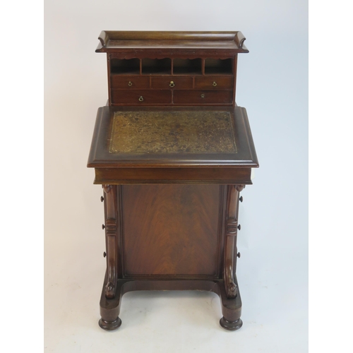 805 - A Victorian Walnut Davenport with a sliding fall and pull up gallery fitted with drawers and pigeon ... 