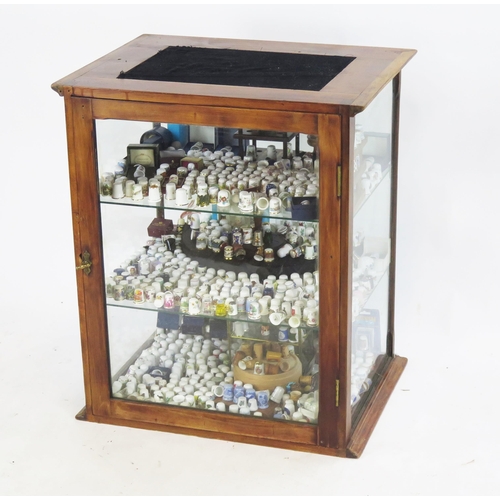 825 - A Glazed Table Top Shop Display Cabinet, 56(w)x45.5(h)x42(d)cm containing a large collection of thim... 