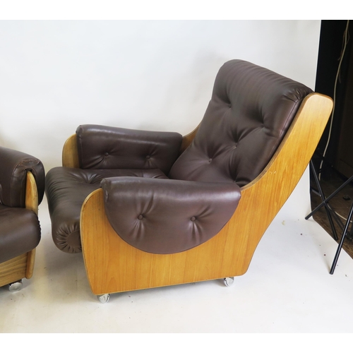 849 - A Pair of G-Plan Saddleback Teak and Leatherette Lounge Chairs and a footstool