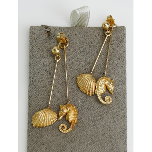 115 - A Pair of 14K Gold Seahorse and Seashell Pendant Earrings, the seahorse element suspended from the b... 