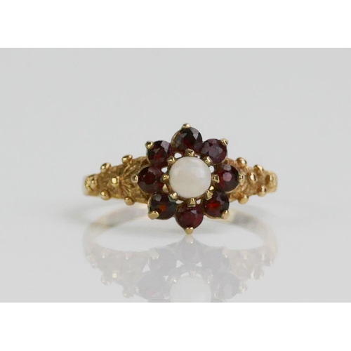 129 - A 9ct Gold, Garnet and Opal Cluster Ring, size L.5, Birmingham marks, 1.89g