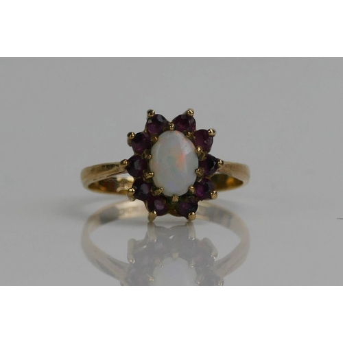 135 - A 9ct Gold, Garnet and Opal Cluster Ring, 12.6x11.2mm head, hallmarked, 2.24g