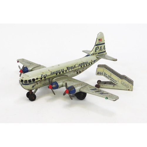 1352 - Gama PAA Strato Clipper Tinplate Battery Operated Airplane in white and silver with blue and red acc... 