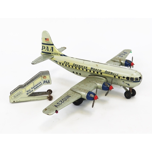 1352 - Gama PAA Strato Clipper Tinplate Battery Operated Airplane in white and silver with blue and red acc... 