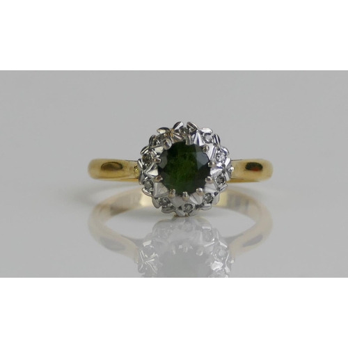 138 - An 18ct Gold, Green Tourmaline and Diamond Cluster Ring, 9.8mm head, size M.5, hallmarked, 4.15g