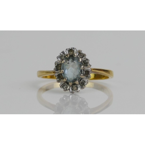 144 - An 18ct Gold, Aqua Marine and Diamond Cluster Ring, size M.5, London marks, 3.04g