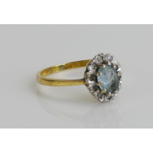 144 - An 18ct Gold, Aqua Marine and Diamond Cluster Ring, size M.5, London marks, 3.04g