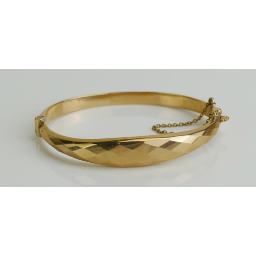 147 - A 9ct Gold Hinged Bangle with faceted top, Birmingham hallmarks, 9.47g