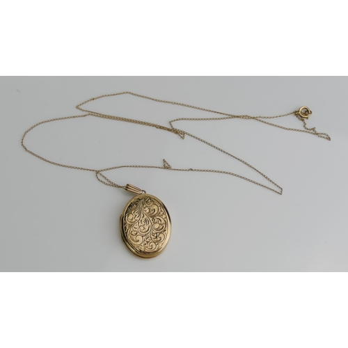 148 - A 9ct Gold Oval Locket with chased foliate scroll decoration and on a yellow metal chain, 34mm drop,... 