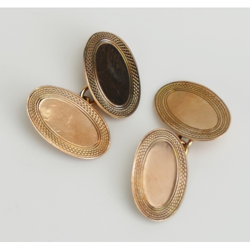 17 - A Pair of 9ct Gold Cufflinks with engine turned decoration, hallmarked, 4.49g. Boxed