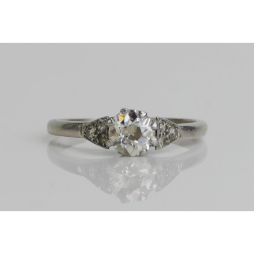 170 - A Platinum and Old Cut Diamond Solitaire Ring with three chips to each shoulder, 5.7mm stone, size M... 