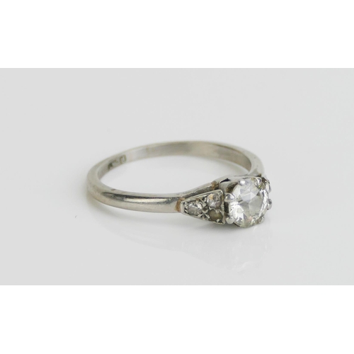 170 - A Platinum and Old Cut Diamond Solitaire Ring with three chips to each shoulder, 5.7mm stone, size M... 