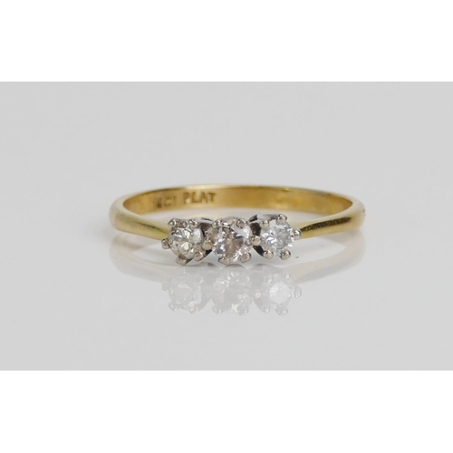 26 - An 18ct Gold and Diamond Trilogy Ring, 3.3mm principal brilliant round cut, platinum set, O.5, stamp... 