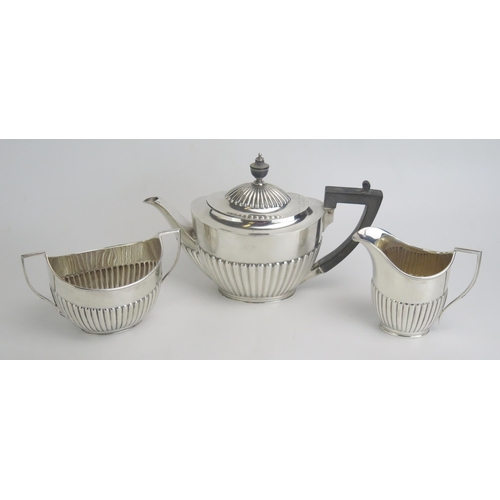 511 - An Edward VII silver teapot, maker Goldsmith & Silversmiths Co Ltd, London 1908, with half reeded de... 