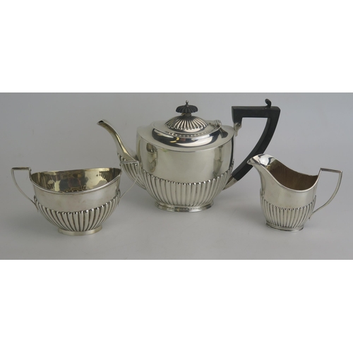 515 - A matched three-piece bachelors silver tea set, various makers and dates, with half reeded decoratio... 