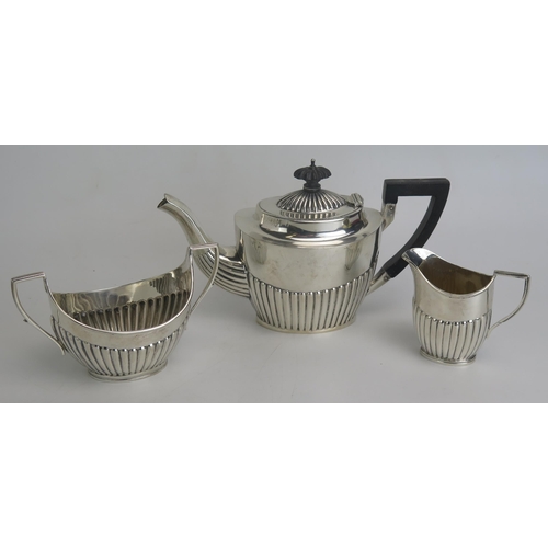 516 - A matched three-piece bachelors silver tea set, various makers and dates, with half reeded decoratio... 