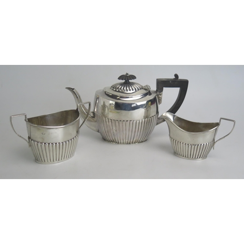 517 - A matched three-piece bachelors silver tea set, various makers and dates, with half reeded decoratio... 