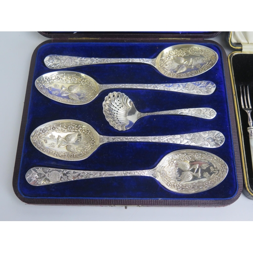 524 - A set of four plated serving spoons, decorated with birds and flowers, together with a matching sift... 