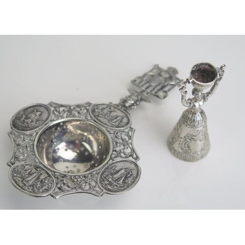 549 - A Dutch silver tea strainer, the pierced bowl on a figural stem of a milkmaid, 14cm long, together w... 