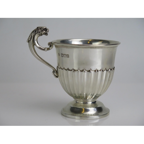 569 - A Victorian silver mug, the bowl maker Wakely & Wheeler, London, 1900, with half fluted decoration, ... 