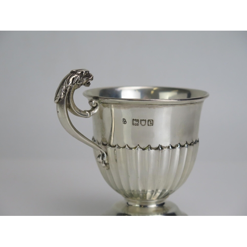 569 - A Victorian silver mug, the bowl maker Wakely & Wheeler, London, 1900, with half fluted decoration, ... 