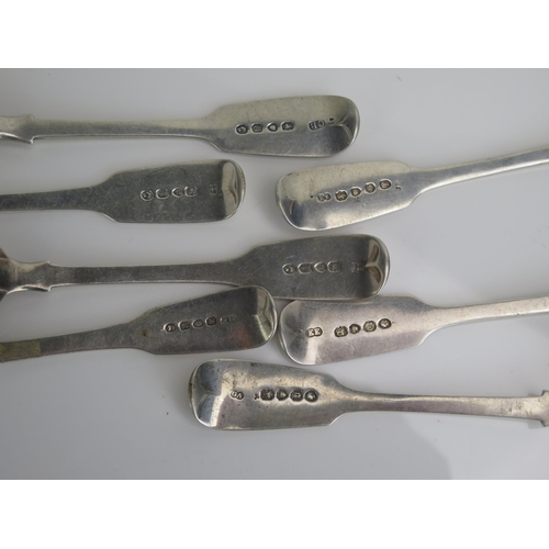 577 - Seven assorted silver Fiddle pattern dessert spoons, various makers and dates, three crested, two in... 